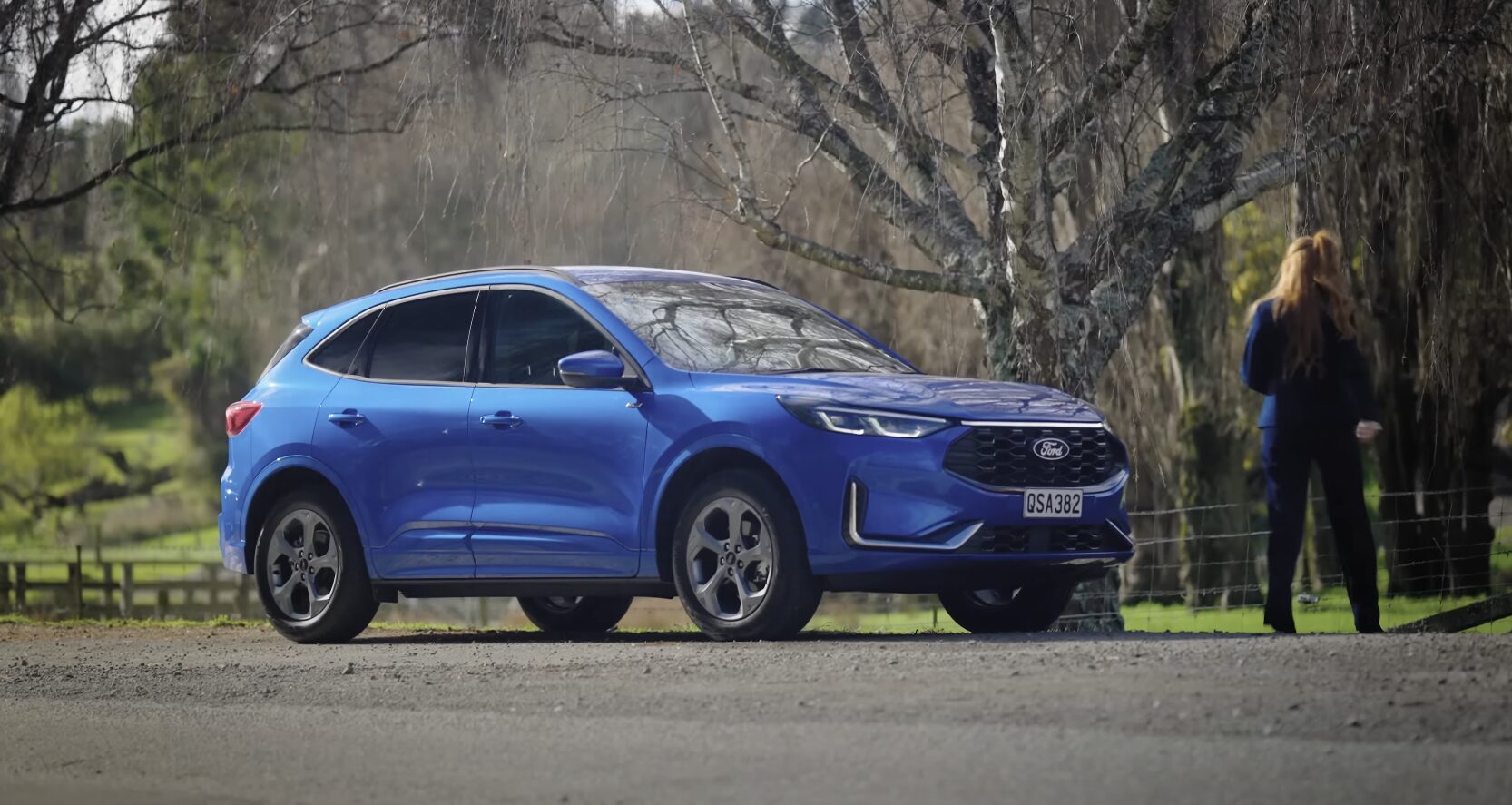 Professional vehicle protection during towing - Flatbed service Blue SUV being professionally towed on flatbed